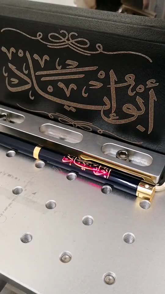 Fiber laser engraving a name on a pen